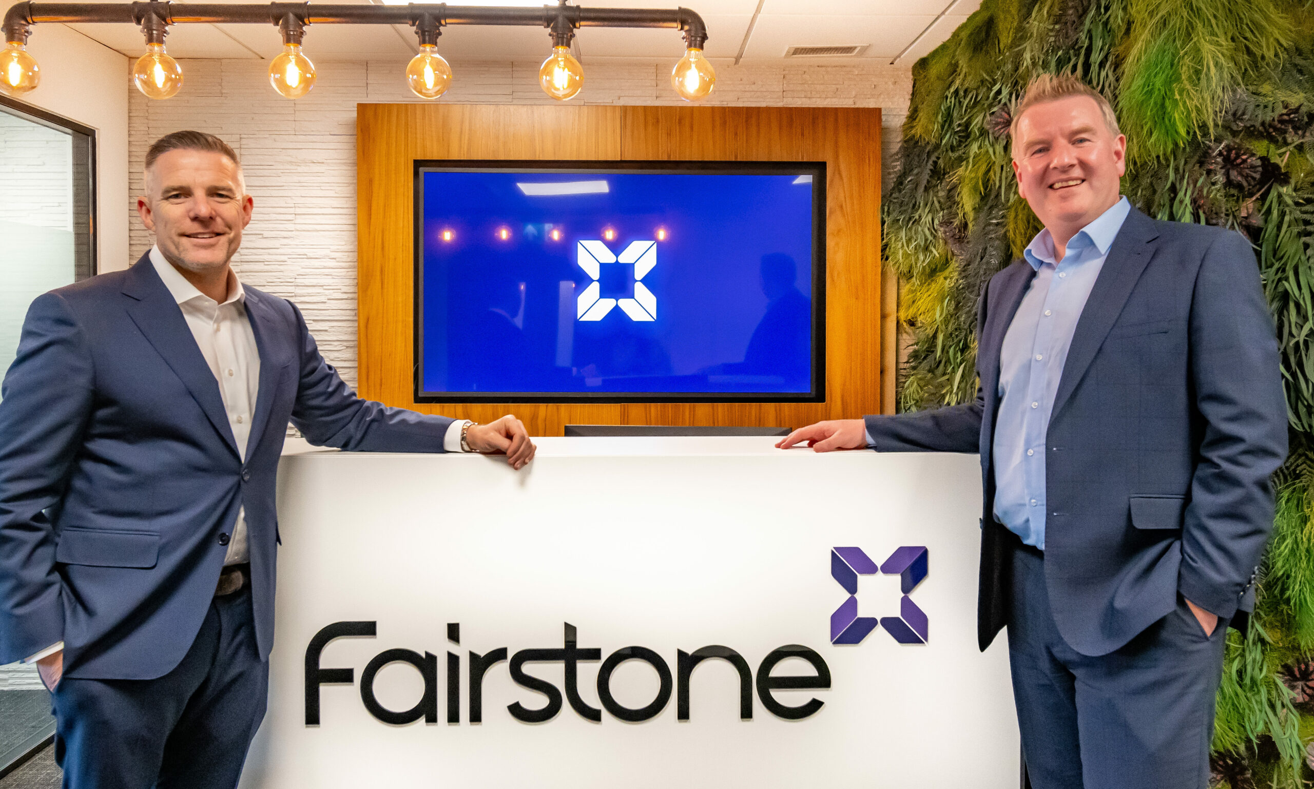 From left Fairstone Ireland CEO Paul Merriman & Conor Carey Fairstone Headford Director with the Fairstone logo background