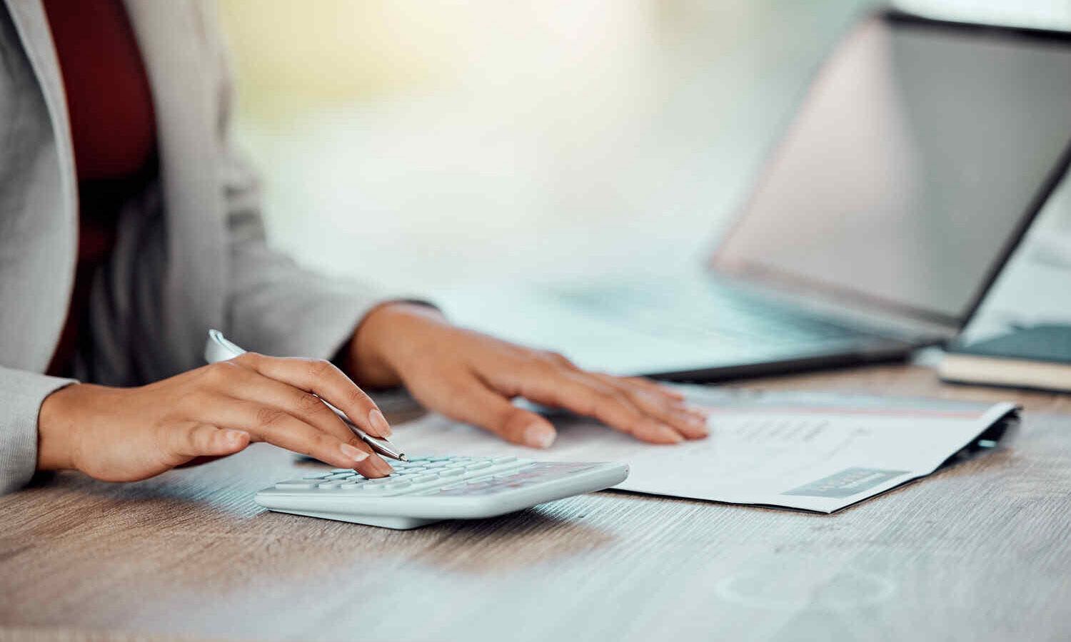 Auditor, banker and business accountant womans hand calculating, planning and doing financial paper.