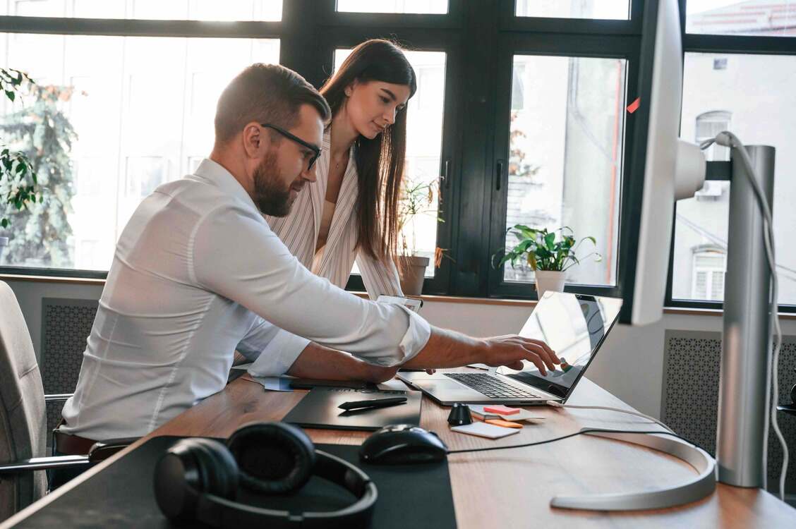 Employer explaining occupational pension schemes to his worker in the modern office.